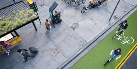 Aufnahme aus der Vogelperspektive einer nachhaltigen Stadt mit Elektrofahrzeugen und öffentlichen Verkehrsmitteln